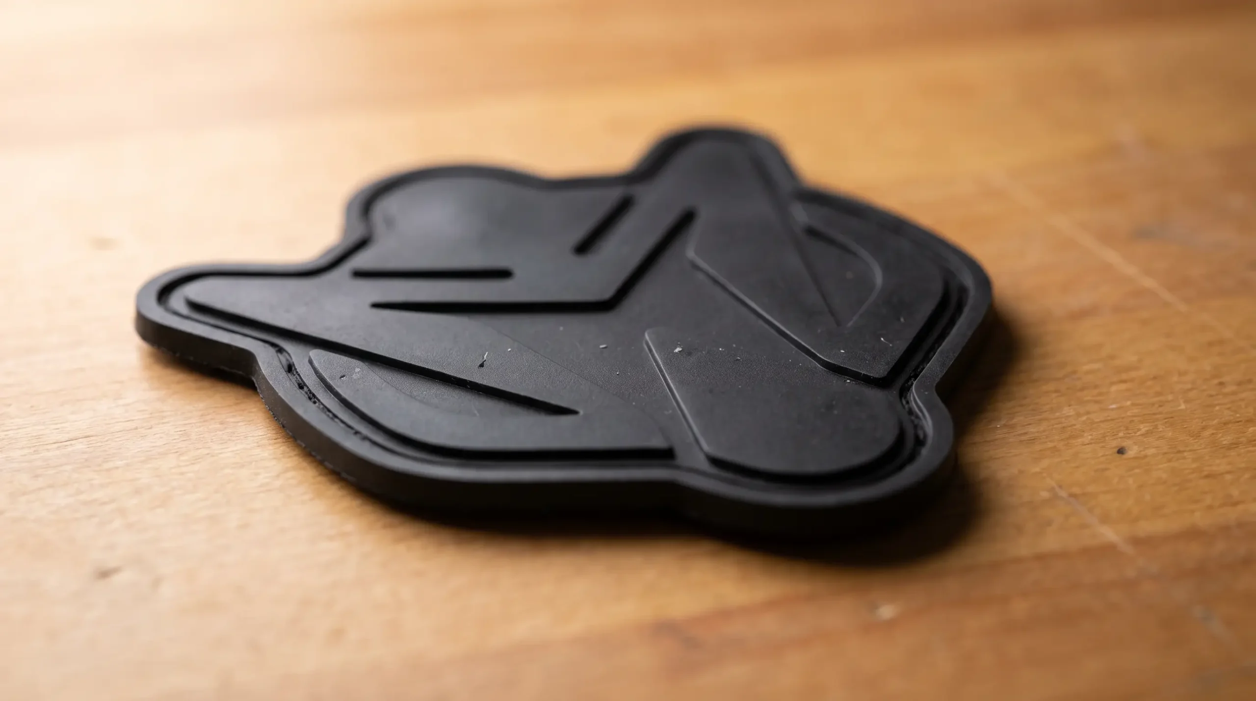 Close-up of the smooth plain reverse of a moulded PVC patch with no attachment layer